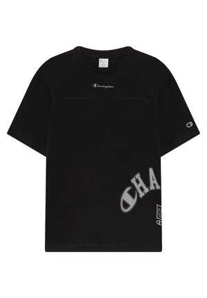 T-shirt en coton noir avec un col rond, des manches courtes et un logo "Champion" imprimé sur la poitrine et sur le côté inférieur. Présente une coupe décontractée.