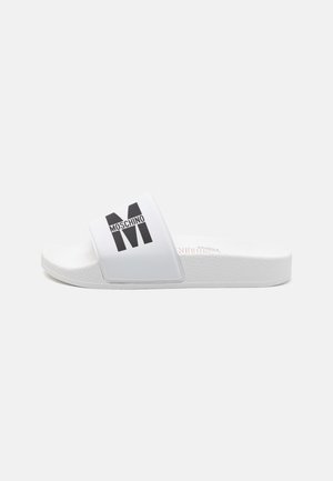 Sandală albă cu talpă texturată, având un logo „Moschino” negru pe o curea lată. Material neted cu un design minimalist.