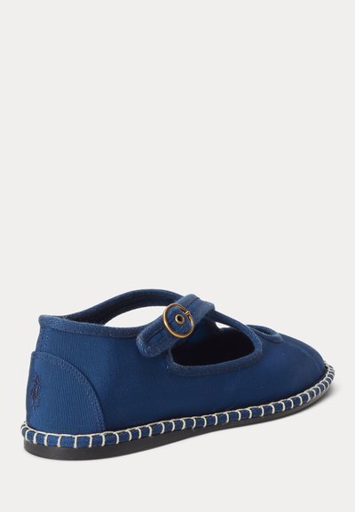 Dječja tamnoplava cipela Mary Jane s remenom na kopču od zlata i bijelim šavovima duž đona.