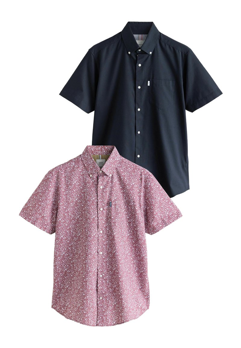 Camicie a maniche corte: una in cotone azzurro navy uniforme con bottoni, una in cotone con motivo floreale rosa con tasca e colletto a bottone.