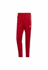 Red athletic pants made of smooth fabric, featuring two side zip pockets, elastic waist, and white stripe accents along the sides.