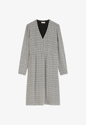 Black and white patterned dress with a V-neckline, long sleeves, and a fitted waist. The fabric has a subtle texture and geometric design.