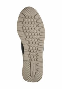Suola di una scarpa con una superficie in gomma testurizzata di un beige chiaro, caratterizzata da motivi circolari e ondulati; nome del marchio e taglia incisi.