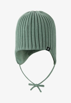 Light green ribbed knit winter hat with ear flaps and tie strings, featuring a small black fabric logo tag on the side.