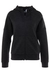 Felpa nera con zip realizzata in tessuto strutturato. Include una tasca frontale, cappuccio regolabile e un logo discreto sulla manica.