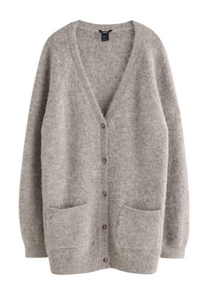 Grå ullkofta med V-ringning, knäppning framtill och två framfickor. Mjuk textur med en något lös passform och ribbade ärmslut.