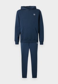 Navy blue hooded sweatshirt with a front pocket and cuffed sleeves, paired with matching joggers featuring elastic cuffs and logo detail.