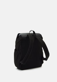 Svart ryggsäck med vadderade axelremmar, sidofickor och ett handtag på toppen, visad bakifrån mot en vit bakgrund.