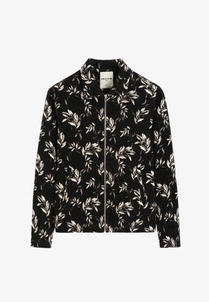 Veste noire zippée avec motif feuilles blanches et grises et petit col, étiquetée Frilivin, manches longues, poches avant.