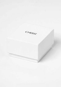 Hvid kvadratisk gaveæske med en glat overflade, der har et sort trykt "CHRIST" logo på toppen. Lukket design med en glidende låg.