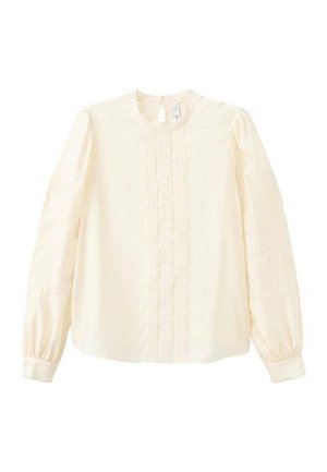 Blouse à manches longues couleur crème avec détails en dentelle sur le devant et les manches, col rond et poignets à revers.