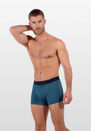 Boxershorts in Marineblau mit einem geometrischen Muster in Hellblau. Mit elastischem Bund und Markenlogo. Aus weichem, glattem Stoff.