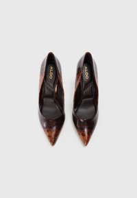 Brown and black pointed-toe high heels with a textured animal print design, featuring a sleek silhouette and a smooth inner lining.