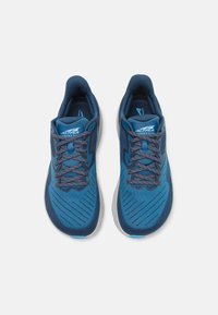 Blue athletic shoes with a textured, breathable upper, featuring dark blue laces and a grey sole. The design includes subtle diagonal stripes.