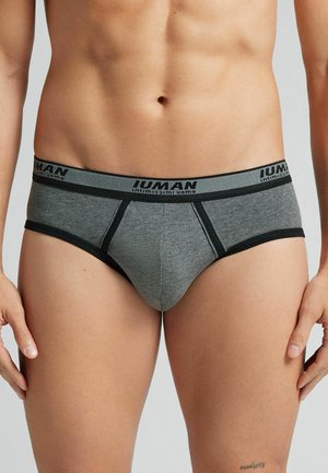 Grijze herenonderbroek met zwarte elastische tailleband met logo. De stof is glad met een aansluitend ontwerp en contrasterende stikseldetails.