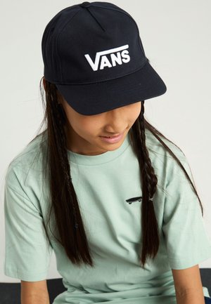 Navy cap with white "VANS" logo, paired with a mint green t-shirt featuring a small black skateboard design. Braided hair visible.