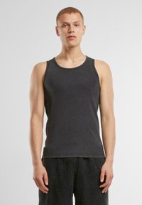 Dunkelgraues Tanktop aus weichem Stoff. Mit Rundhalsausschnitt und ärmellosem Design. Schlichte Ästhetik ohne sichtbare Muster.