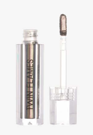 Fard à paupières liquide dans un tube transparent avec une finition argent irisé. Comprend un applicateur plat pour une application précise.