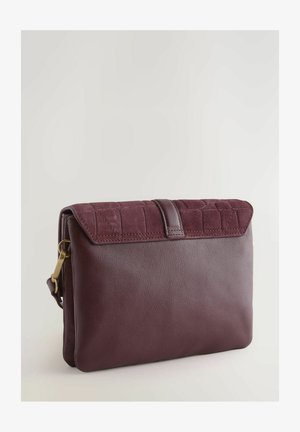 Maroon leather bag with a textured suede flap. Features a smooth surface, rectangular shape, and gold hardware detail on the side.