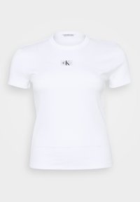 T-shirt bianca a maniche corte in texture a costine, con una piccola etichetta logo sul petto. Collo rotondo e design slim fit.