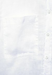 White linen shirt with a simple design, featuring a single chest pocket and pearl buttons along the front. Smooth, lightweight texture.