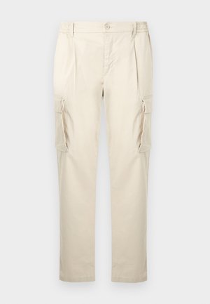 Béžové pracovné nohavice vyrobené z mäkkej, ľahkej látky. Majú voľný strih, elastický pás a dve bočné vrecká s chlopňami.