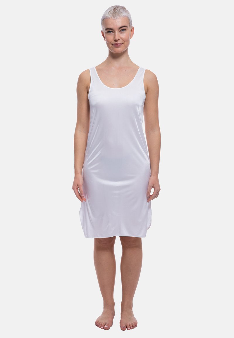 Abito bianco senza maniche realizzato in morbido tessuto leggero, caratterizzato da una vestibilità rilassata e una lunghezza fino al ginocchio. Stile minimalista senza motivi.