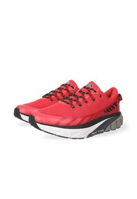 Red athletic shoes with a mesh upper, black accents, and textured black laces. Features a thick white midsole and a unique pivoting heel design.
