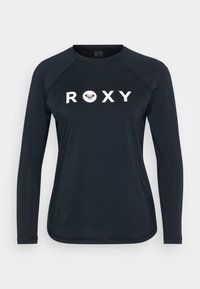 Jūras flotes krāsas garām piedurknēm krekls ar uzrakstu "ROXY" lieliem baltiem burtiem priekšā, izgatavots no mīkstas, gludas auduma ar raglan piedurknēm un noapaļotu apakšmalu.
