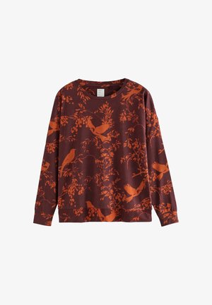 Long-sleeve top in burgundy with an orange bird and floral pattern. Round neckline, soft texture, relaxed fit, and slightly draped hem.