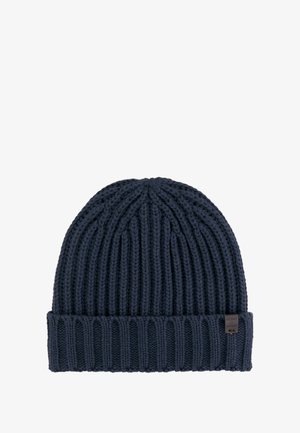 Navy knitted beanie hat with ribbed texture, featuring a folded cuff and a small brand label on the side.