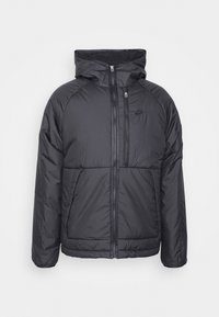 Svart puffjacka med huva, med dragkedja framtill, två framfickor och en diskret logotyp på bröstet. Slät, kviltad textur.