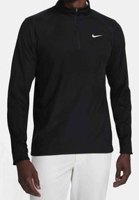 Pullover nero a maniche lunghe con colletto a zip a un quarto e logo Nike bianco. Presenta una texture liscia e una vestibilità atletica. Adatto per l'abbigliamento sportivo.