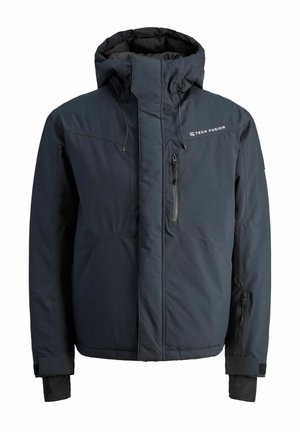 Veste isolante bleu marine avec un col haut, une capuche réglable, une poche zippée et des poignets élastiques. Elle présente un logo sur la poitrine.