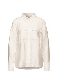 Camisa de manga corta color crema claro con cierre de botones en la parte frontal, dos bolsillos en el pecho y un corte relajado. Fabricada con una tela ligera y texturizada.