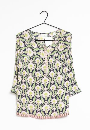Floral-patterned blouse with short sleeves, green and pink hues on a dark background, features a V-neck and decorative trim at the hem.