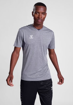 Grå atletisk t-shirt med korte ærmer, v-hals og mørke sidelogoer. Har et logo på venstre bryst. Glat stofstruktur.