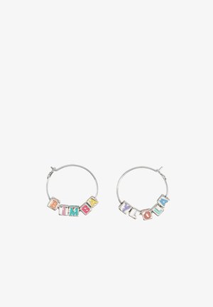 Silver hoop earrings featuring colorful letter beads spelling "BIMBA" and "YLOLA." Beads include pink, blue, green, and yellow accents.