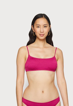 Magenta bikini top with thin straps, textured fabric, and a rectangular design. The ensemble features matching bottoms with similar texture.
