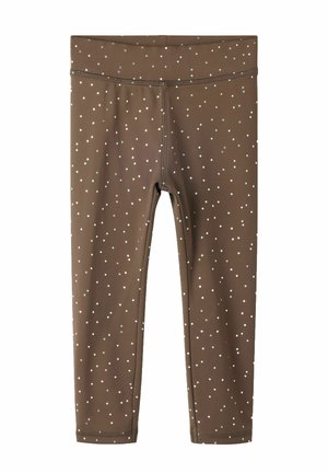 Leggings marron à petits pois blancs, dotés d'une taille haute et de coutures visibles à l'avant et à l'ourlet.