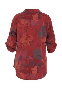 Blouse rouge à manches longues avec poignets retroussés, présentant un motif floral foncé et un empiècement au dos, vue de dos.