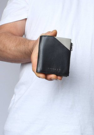 Black leather wallet with gray accents, rectangular shape, textured surface, featuring a zipper and embossed logo on the bottom.