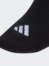 Calzino nero con motivo a maglia strutturata e punta arrotondata. Accenti del logo bianco sono visibili vicino alla punta.