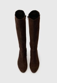 Brown suede knee-high boots with a tapered toe, side zip closure, and smooth texture. Features a notched top for added style.