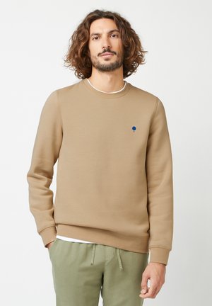 Brown sweatshirt with a crew neck, long sleeves, and a small blue tree logo on the chest. Made of soft, textured fabric.