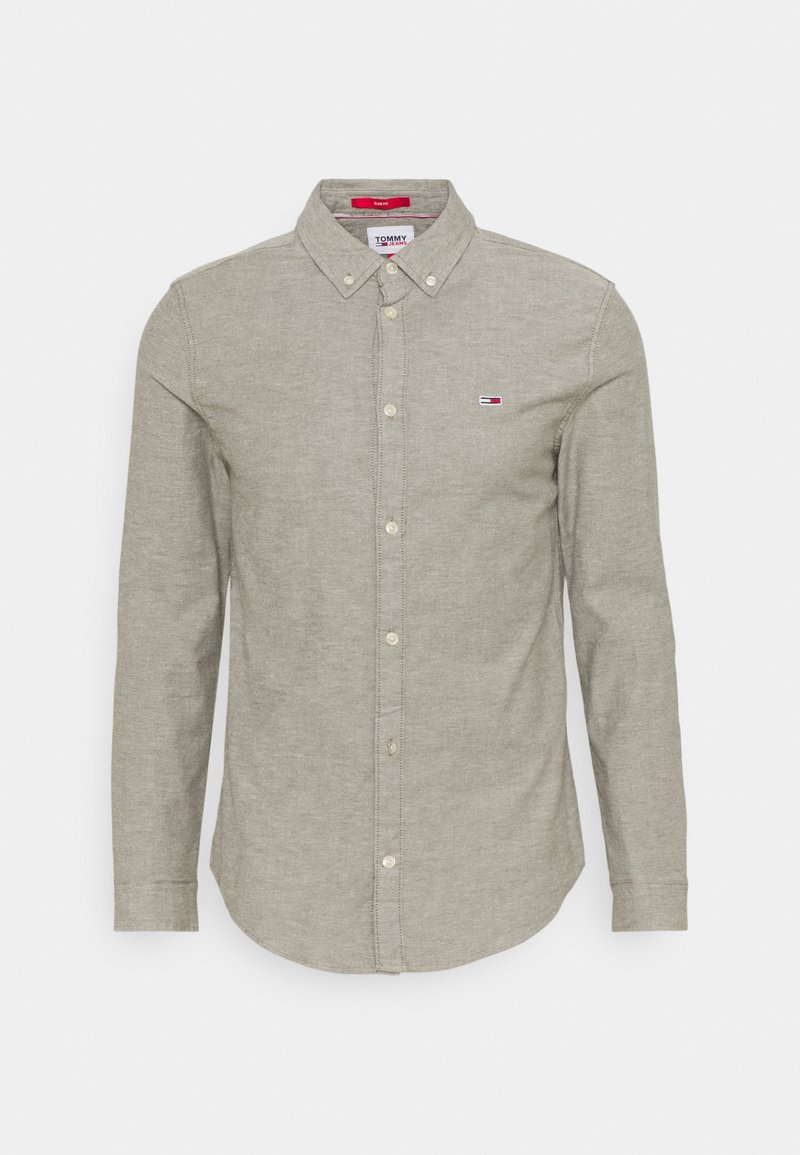 Green button-up shirt with long sleeves, collared design, and small logo on the chest. Soft texture and rounded hemline.
