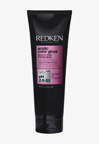 Redken zure kleur gloss in een zwarte tube met een glanzende afwerking. Heeft een roze label met productdetails, 8,45 fl oz, en pH-bereik.