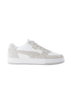 Baskets basses Puma blanches et gris clair avec détails en daim et lacets, vues de profil sur fond blanc.