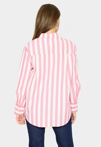 Long-sleeve shirt with a back view, featuring pink and white vertical stripes, a collar, and buttoned cuffs. Made of lightweight fabric.