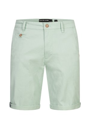 Lys grønne shorts lavet af bomuld med en glat tekstur. Har en knaplukning, sidelommer og op-rullede ærmer. Casual design.